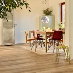 Experienced flooring installer laying engineered hardwood in a contemporary home