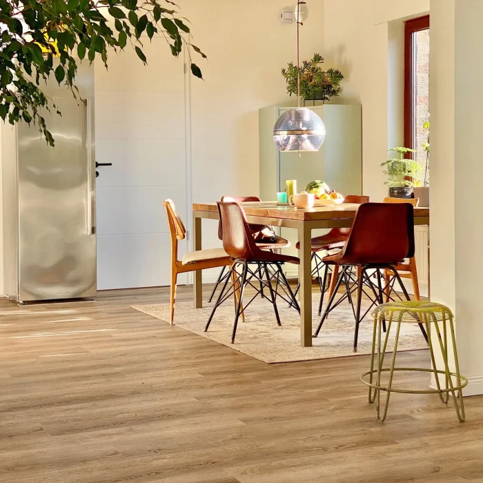 Experienced flooring installer laying engineered hardwood in a contemporary home