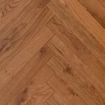 Close-up of HERRINGBONE RUSTIC HONEY flooring showing detailed surface texture and finish