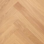 Close-up of HERRINGBONE SELECT BANANA SONG flooring showing detailed surface texture and pattern