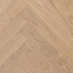Close-up of HERRINGBONE RUSTIC CW WC B flooring showing detailed surface texture and geometric pattern